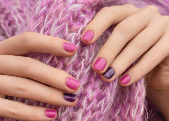Pink nail design. Manicured female hands on pink background